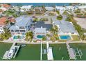 Aerial view of a waterfront property with multiple homes and docks at 65 Dolphin Dr, Treasure Island, FL 33706