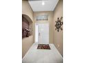Bright and airy entryway with tile flooring and a decorative wall accent at 1215 Dustan Pl, Trinity, FL 34655