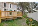 Wooden deck overlooks a partially fenced backyard at 12430 81St Pl, Seminole, FL 33772