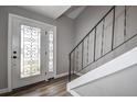 Entryway with white door, wood-look floors and staircase at 12430 81St Pl, Seminole, FL 33772