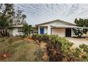 Charming single story home with a spacious front yard and attached garage at 1295 56Th N St, St Petersburg, FL 33710