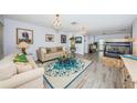 Bright and airy living room with comfortable seating, a fireplace, and large TV at 1295 56Th N St, St Petersburg, FL 33710