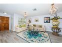 Living room with light colored couches, a large rug, and a decorative centerpiece at 1295 56Th N St, St Petersburg, FL 33710