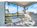 Relaxing screened balcony overlooking a tranquil lake and lush landscape at 1308 Alhambra Dr, Apollo Beach, FL 33572