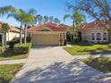 Two-story house with tile roof and a large driveway at 14608 Mirasol Manor Ct, Tampa, FL 33626