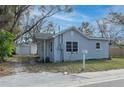 Gray house with a detached garage, and a small front yard at 1575 S Martin Luther King Jr Ave, Clearwater, FL 33756