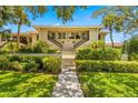 Building exterior with manicured landscaping and walkway at 1812 Mariner Dr # 137, Tarpon Springs, FL 34689
