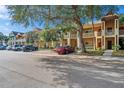 Side view of a two-story building showcasing multiple units and parking spaces at 2292 Austrian Ln # 22, Clearwater, FL 33763