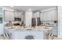 Modern kitchen with granite countertops and stainless steel appliances at 688 157Th E Ct, Bradenton, FL 34212