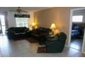Spacious living room with tile floors and dark leather furniture at 12172 Wild Acres Rd, Largo, FL 33773