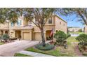 Two-story house with a two-car garage and a view of a lake at 17523 Stinchar Dr # 17523, Land O Lakes, FL 34638