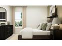 Bedroom with dark brown bed frame and neutral decor at 17664 Shirewood Way, Land O Lakes, FL 34638