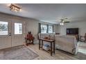 Spacious living area with comfortable seating, large windows, and a ceiling fan at 195 Rusk Cir, Spring Hill, FL 34606