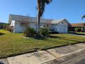 Well-maintained house with a lush lawn and palm tree at 4415 Great Lakes N Dr, Clearwater, FL 33762