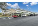 Building's exterior showcasing parking and landscaping at 4910 Bay Ne St # 109, St Petersburg, FL 33703
