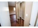 Bedroom with dark wood flooring and mirrored closet doors at 7323 Belvedere Ter, New Port Richey, FL 34655