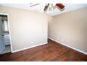 Well-lit bedroom with wood flooring and access to bathroom at 7323 Belvedere Ter, New Port Richey, FL 34655