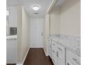 Condo entry with white cabinets and wood flooring at 90 S Highland Ave # 102, Tarpon Springs, FL 34689