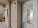 Condo entry with white door and view into kitchen at 90 S Highland Ave # 102, Tarpon Springs, FL 34689