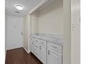 Condo entry with white cabinets and wood flooring at 90 S Highland Ave # 102, Tarpon Springs, FL 34689