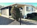Front view of a mobile home with a lamp post and landscaping at 9790 66Th N St # 312, Pinellas Park, FL 33782