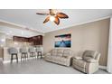 Living room with recliner sofas and kitchen bar at 7069 Key Haven Rd # 504, Seminole, FL 33777