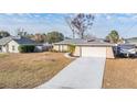 Single-story house with attached garage and fenced yard at 11201 Mercedes St, Spring Hill, FL 34609