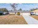 Single-story house with attached garage and fenced yard at 11201 Mercedes St, Spring Hill, FL 34609