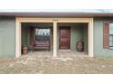 Front porch with wooden bench and barrel accents at 12404 Dolquieb Ln, Weeki Wachee, FL 34614