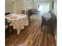 Elegant dining area with hardwood floors and spiral staircase at 2066 Sunset Point Rd # 97, Clearwater, FL 33765