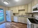 Well-equipped kitchen with granite counters and wood flooring at 2066 Sunset Point Rd # 97, Clearwater, FL 33765