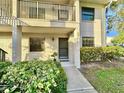 Condo entrance with walkway and lush landscaping at 2119 Elm St # 101, Dunedin, FL 34698