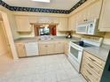 Eat-in kitchen with white appliances and ample counter space at 2119 Elm St # 101, Dunedin, FL 34698
