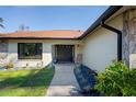 Inviting front entrance with a dark brown door and landscaped walkway at 4030 Saturn Rd, Brooksville, FL 34604