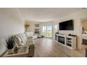 Bright living room with white sofas, fireplace, and hardwood floors at 4516 Seagull Dr # 419, New Port Richey, FL 34652
