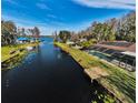Lakefront property with a private dock and a large backyard pool at 4747 Tamney Ln, Land O Lakes, FL 34639