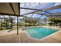 Inviting screened-in pool with a spa and a view of the lake at 4747 Tamney Ln, Land O Lakes, FL 34639