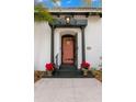 Inviting front entrance with coral door and ornate details at 706 15Th Ne Ave, St Petersburg, FL 33704