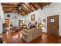 Spacious living room with beamed ceiling, fireplace, and tile floors at 706 15Th Ne Ave, St Petersburg, FL 33704