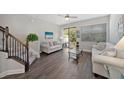 Open living room with hardwood floors, and access to balcony at 9236 Fox Sparrow Rd, Tampa, FL 33626