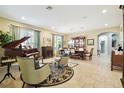 Elegant living room features a grand piano, comfortable seating, and a formal dining area at 1116 Hillandale Reserve Dr, Tampa, FL 33613