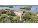 Aerial view of home on waterfront property with lush landscaping and boat access at 1571 Oceanview Dr, St Petersburg, FL 33715