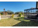 Spacious backyard with hot tub and screened enclosure at 17671 Bright Wheat Dr, Lithia, FL 33547
