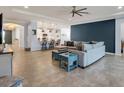 Open living room with sectional sofa and kitchen view at 17671 Bright Wheat Dr, Lithia, FL 33547
