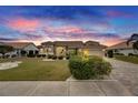One-story house with tile roof and landscaping, at sunset at 2003 Captiva Ct, Sun City Center, FL 33573