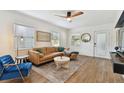 Light and airy living room with a stylish leather couch and large windows at 2126 7Th N Ave, St Petersburg, FL 33713