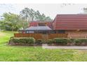 Townhouse with red tile roof and fenced yard at 2601 2Nd Ct, Palm Harbor, FL 34684