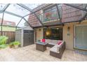 Screened patio with seating area, fire pit, and storage shed at 2601 2Nd Ct, Palm Harbor, FL 34684