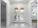 Bright entryway with double doors and marble flooring at 2972 Lake Saxon Dr, Land O Lakes, FL 34639