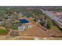 Aerial view showing home, pool, barn, pond and large lot at 3050 Maple Trce, Tarpon Springs, FL 34688